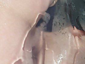 Coloured dildo close by shower